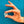 Hand holding a small round object against a blue background